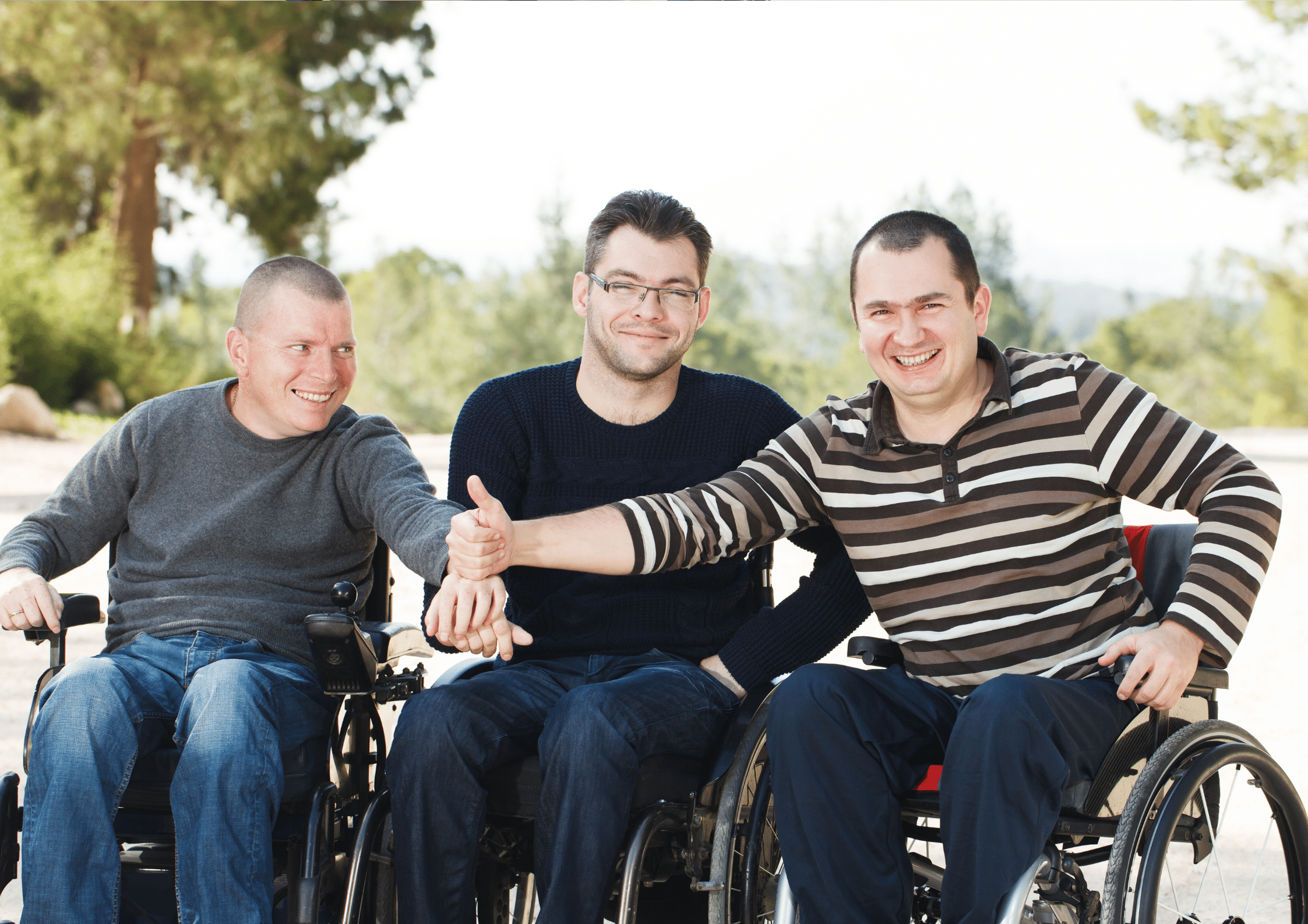 three men in wheelchairs