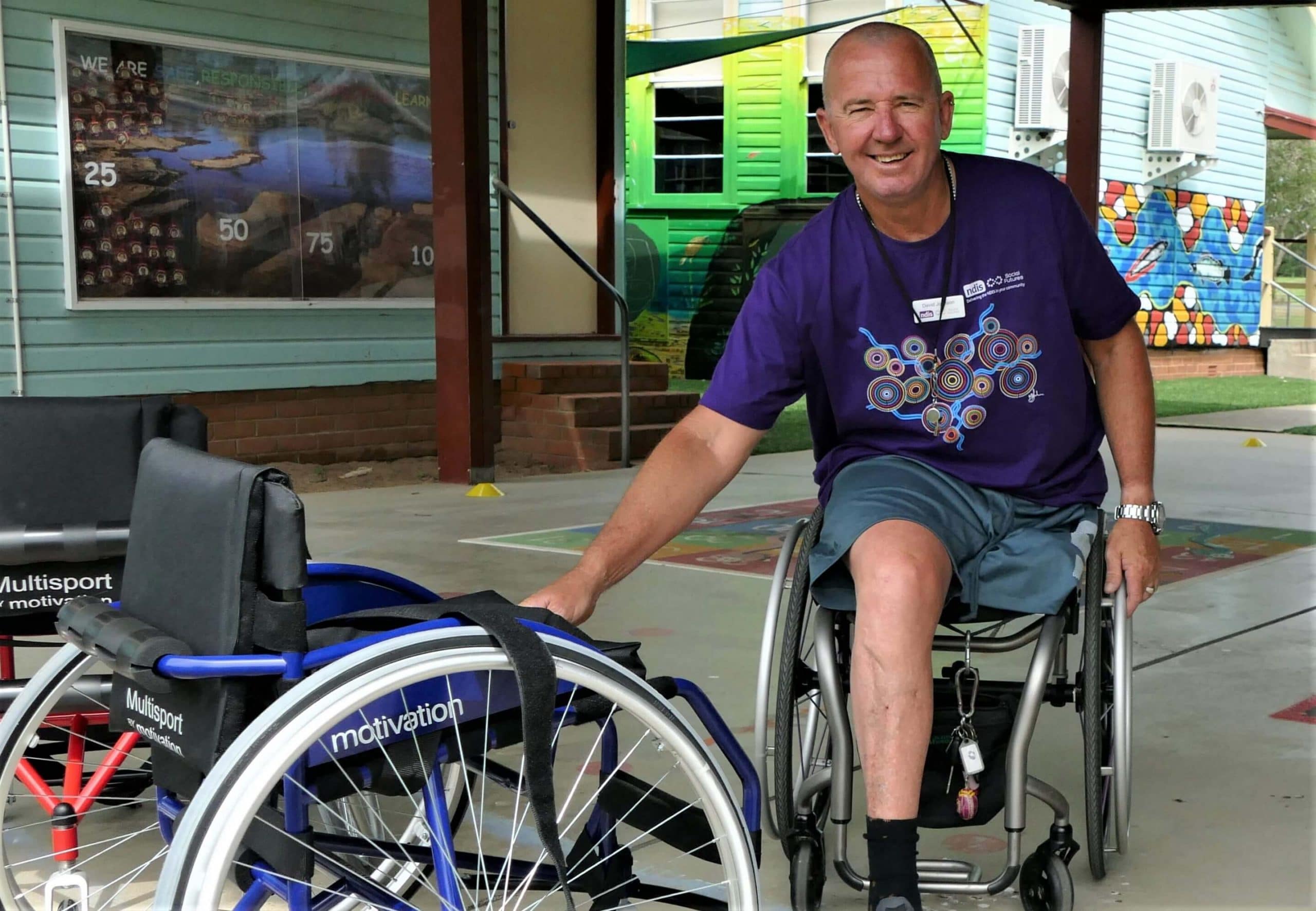 David Johnson sitting in his wheelchair smiling