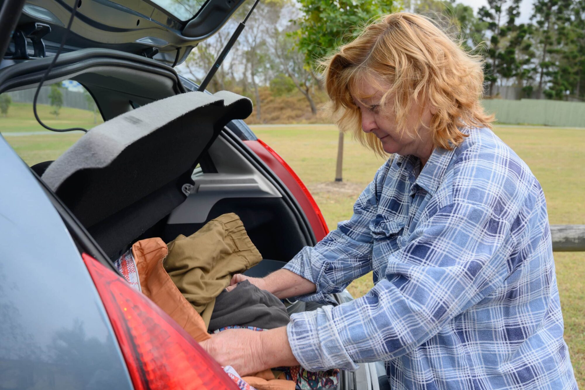 Homeless woman opens car boot