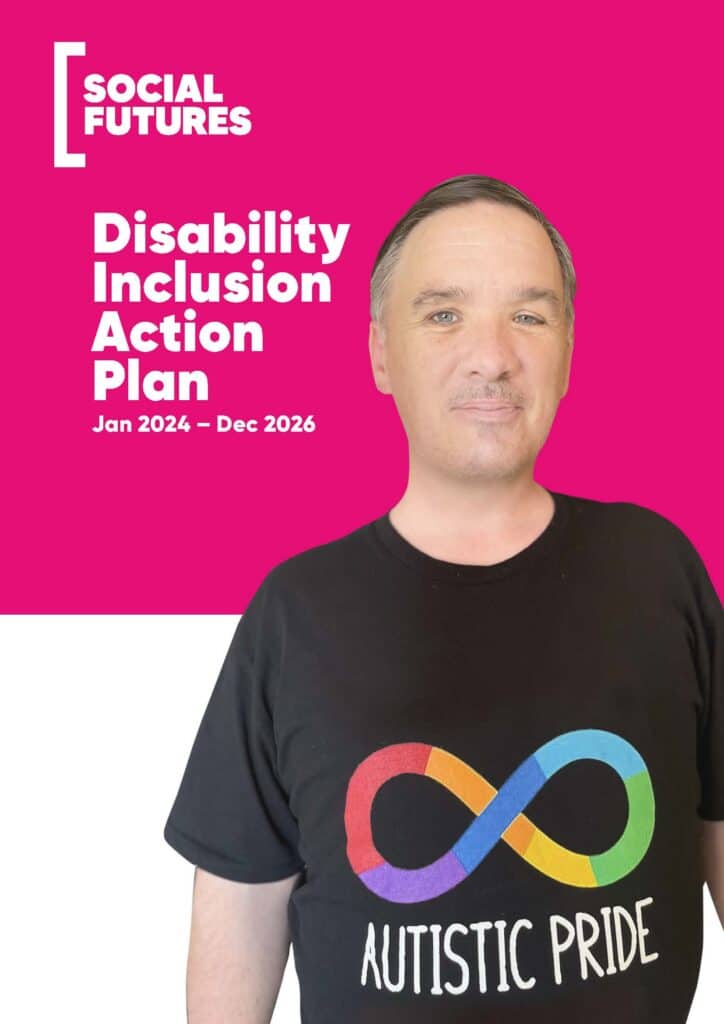 man with short brown hair, blue eyes and wearing a black shirt with autistic pride rainbow infinity logo