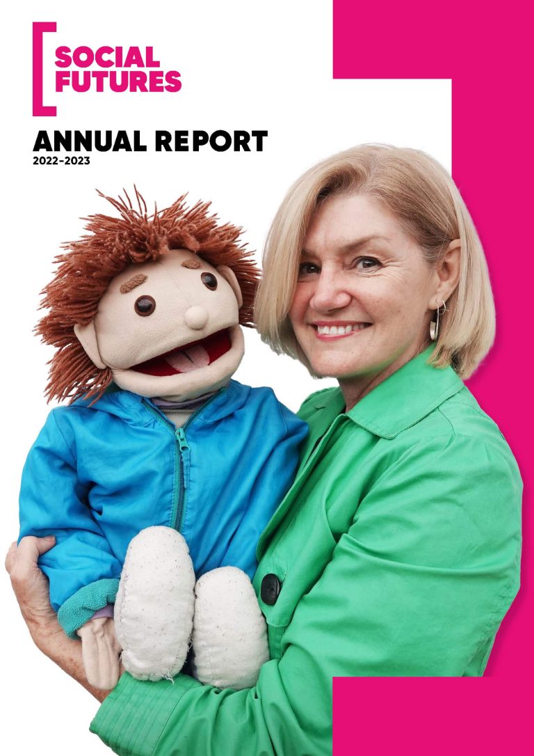 Annual Report front page with Social Futures staff member Lisa Wilson smiling and holding Jack the Puppet