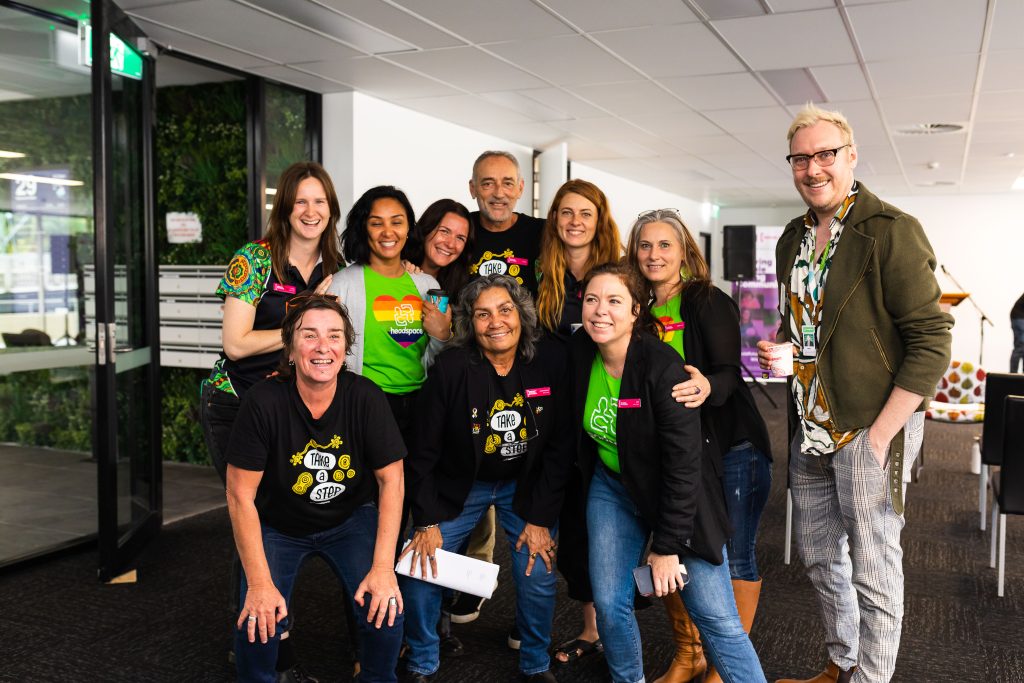 the headspace team all together, in a group, smiling sat the camera. 