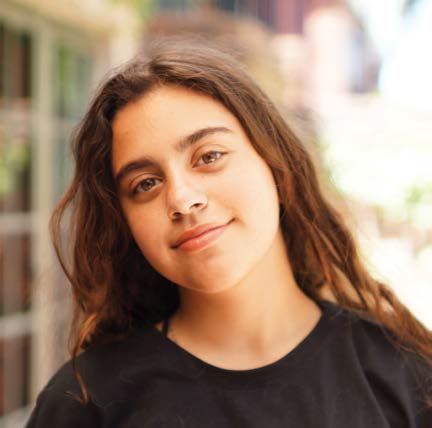 Teenage girl with long dark hair and black shirt