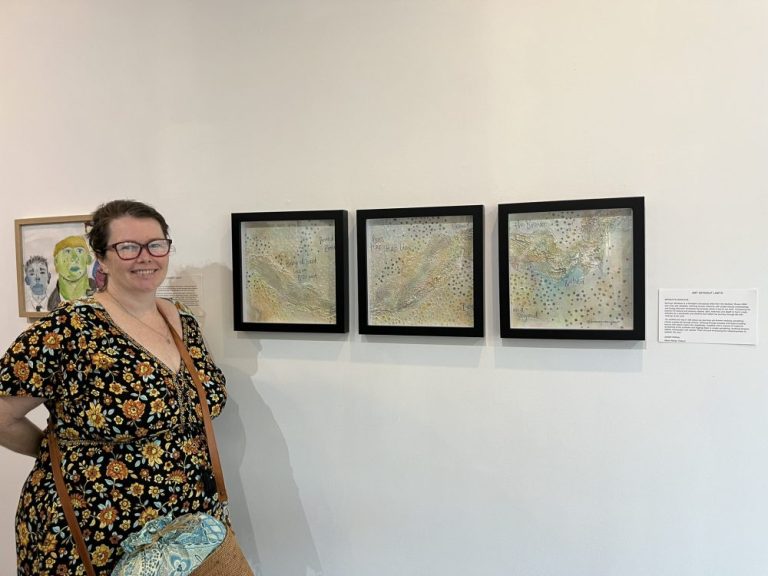 Art Without Limits artist Bronwyn Boniface in front of her paintings