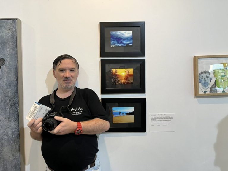 Art Without Limits artist Chris Erickson in front of his photography