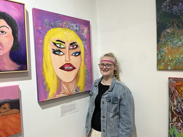 Art Without Limits artist Samara Rose Preecee in front of her Taylor Swift paintings