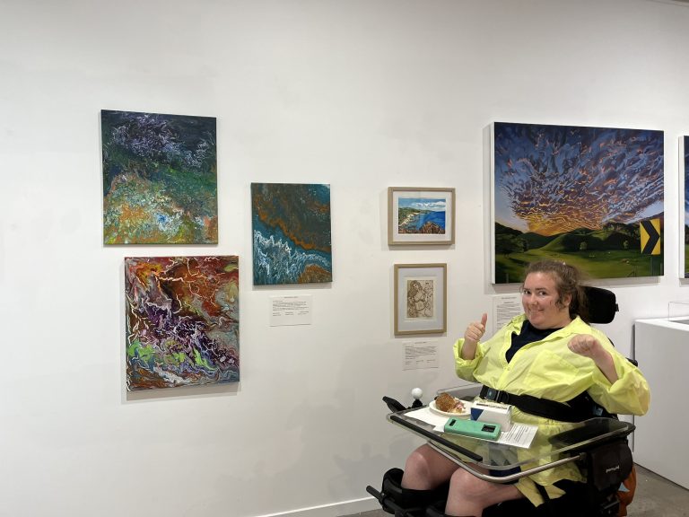 Art Without Limits artist Stephanie Collas in front of her art