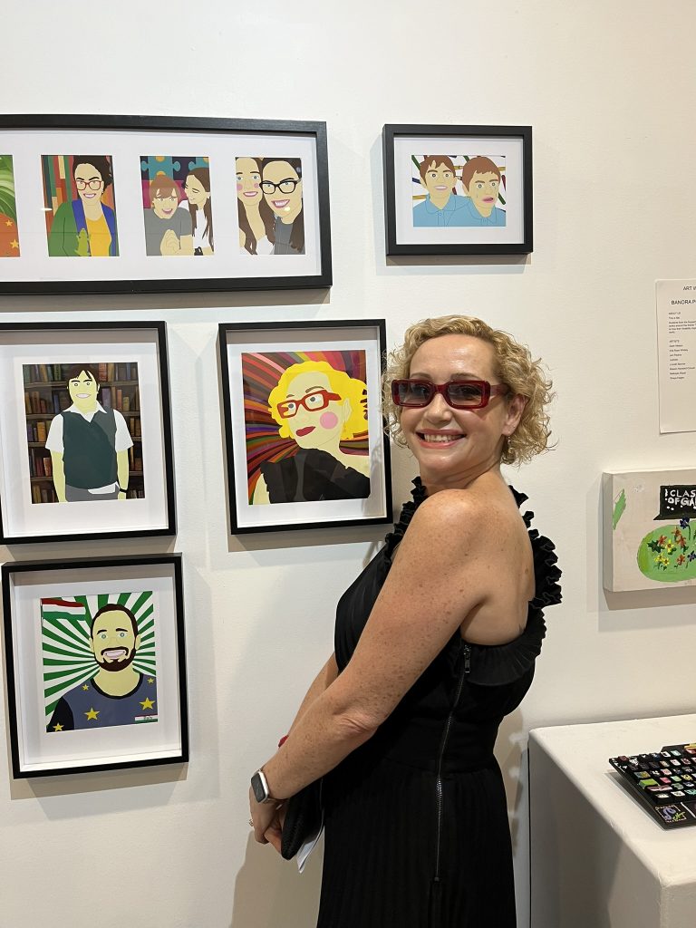 Blonde woman wearing sunglasses viewing Riley Treloars artwork series at Art Without Limits Exhibition