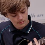 student playing guitar