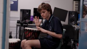 Student playing drum