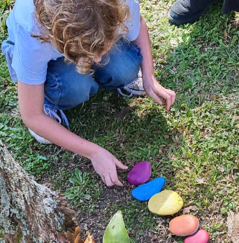 Child painting rocks at Queer Family Sprouts program
