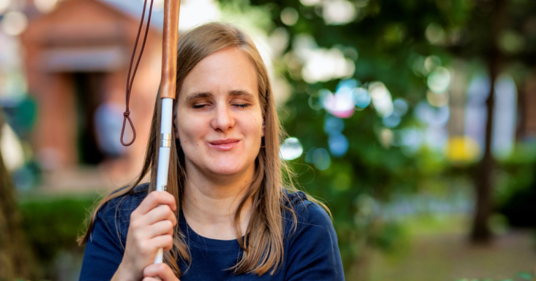 Blind woman smiling outside