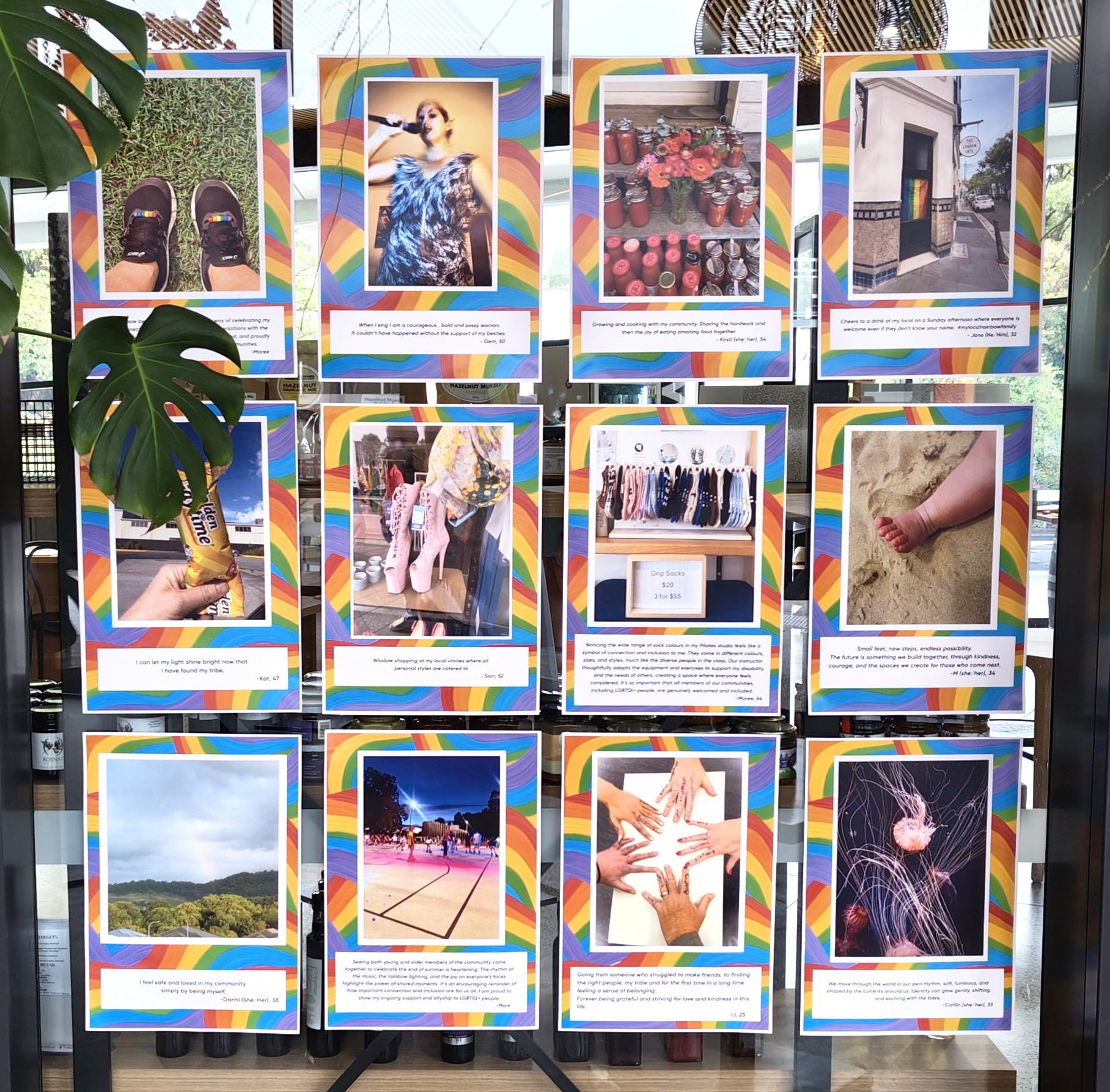 Shows a glass window filled with rainbow framed photographs