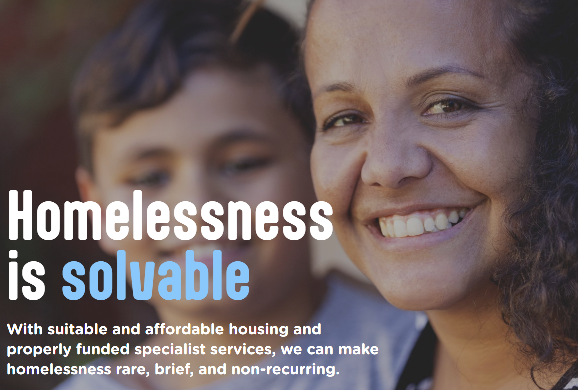 Image reads: 'Homelessness Is Solvable' and shows a mum smiling with her son