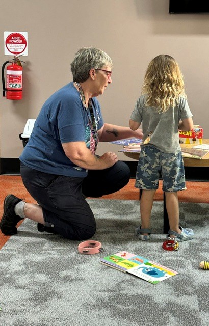 Cathy and a toddler read together